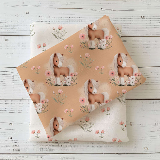 Kinderstoff Blütenpony mit Pony Motiv und Blumen auf warmem Hintergrund, Jersey French Terry und Rib Jersey Stoff Meterware für Baby und Kinderkleidung